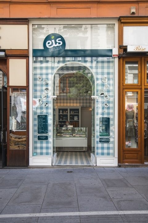 A tiled shopfront under a blue sign reading eis, seen from across the street