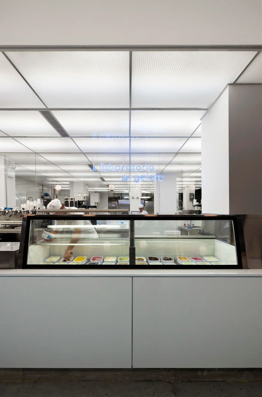 The white interior of the shop, freezer cases along the counter