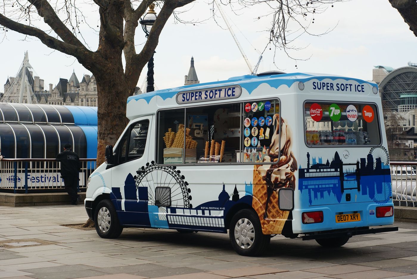 A van lettered SUPER SOFT ICE parked by the Festival Pier, the London Eye and Parliament behind it
