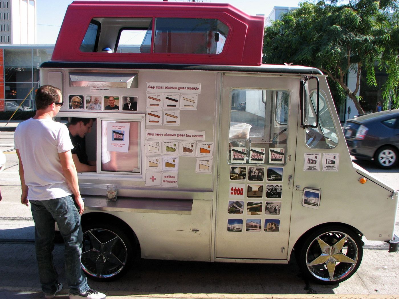 A man ordering at the window of a Coolhaus ice-cream truck