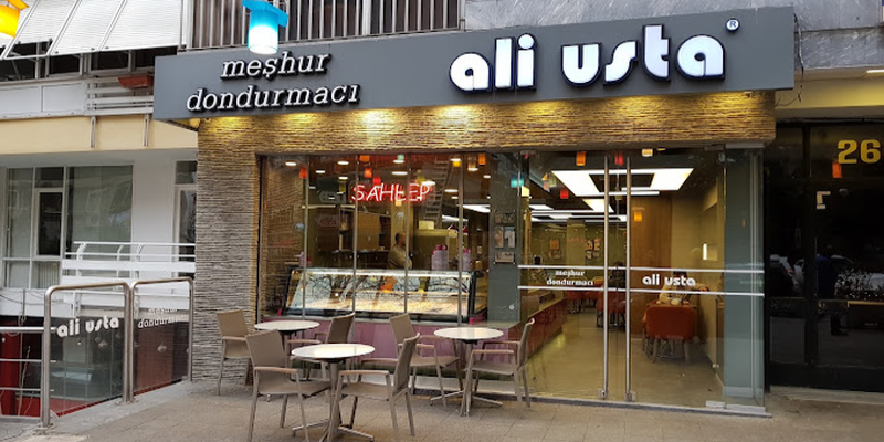 The shopfront under a sign reading Meshur Dondurmaci Ali Usta, tables set out on the pavement