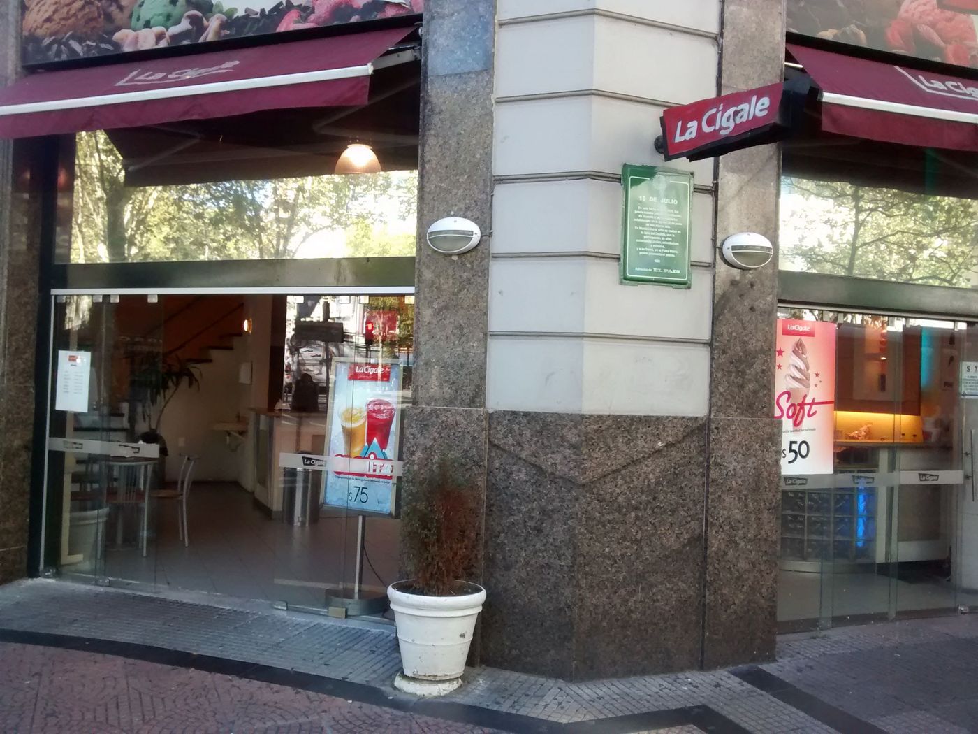 The La Cigale corner shopfront, its awnings out over the pavement