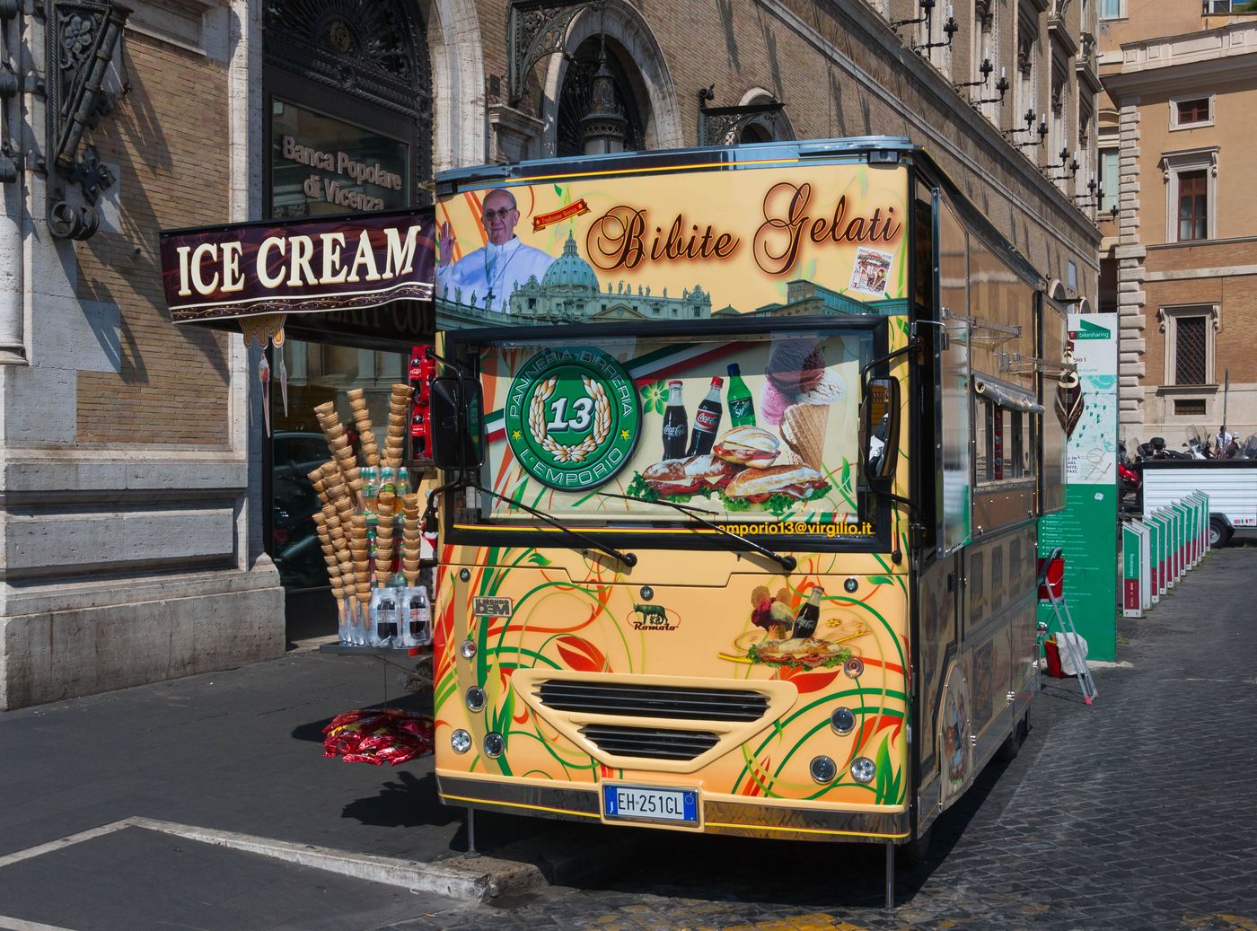 A vintage-styled Bibite Gelati ice-cream truck parked on a Rome street beneath an ICE CREAM sign