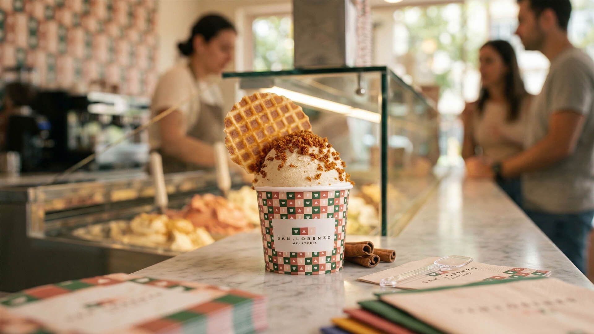 Customers at the counter, the gelato case between them and the staff