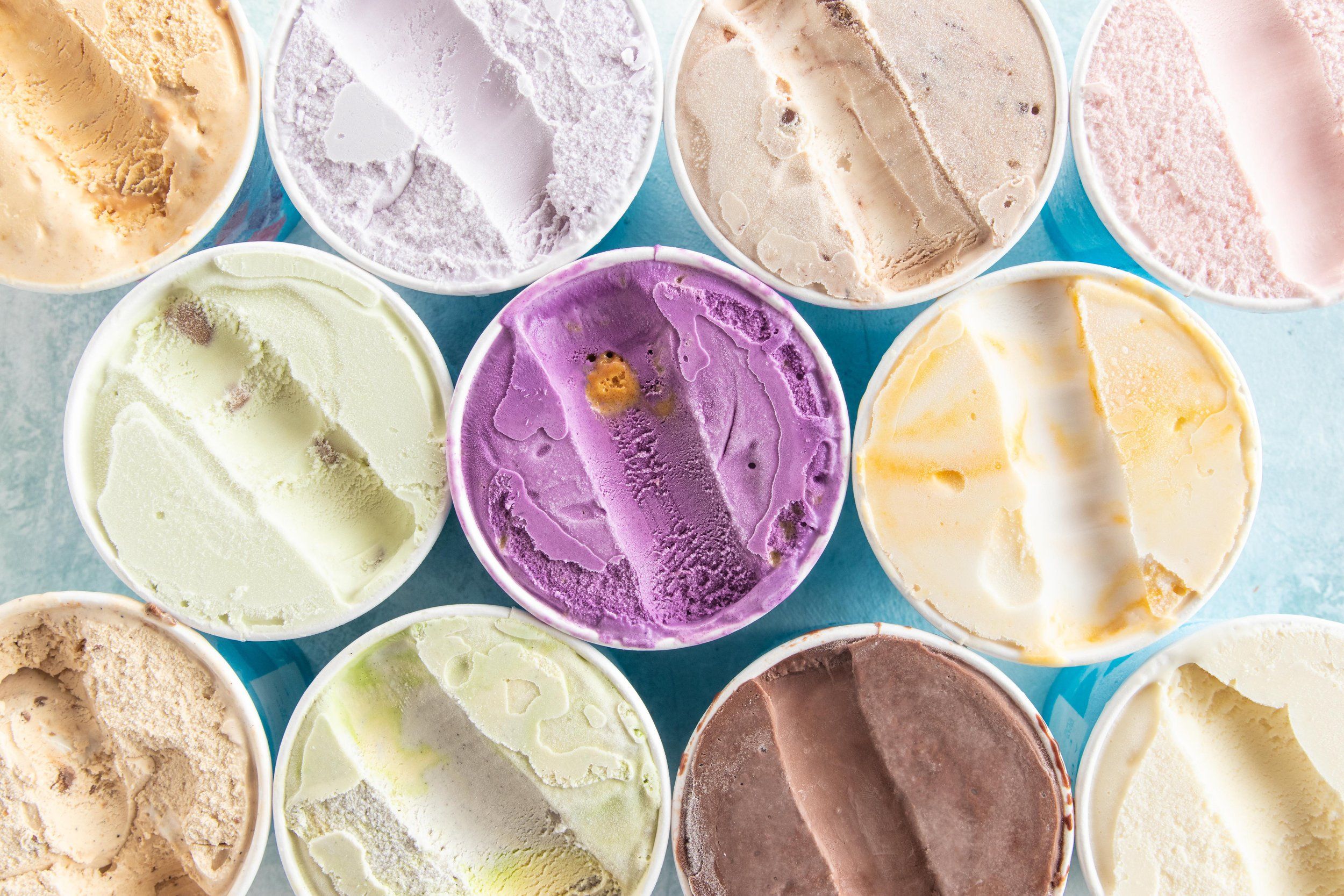 Open tubs seen from above in pale green, lilac, cream and pink