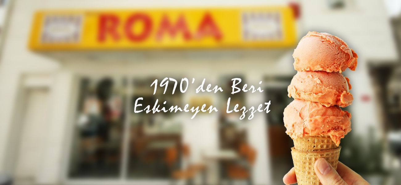 A cone of three orange scoops held up in front of the shop's yellow ROMA sign